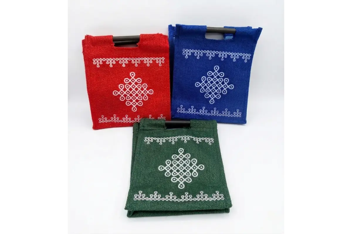 Bulk stacks of Jute Kolam Kattapai bags ready for wholesale return gift orders at Puja Celebrations