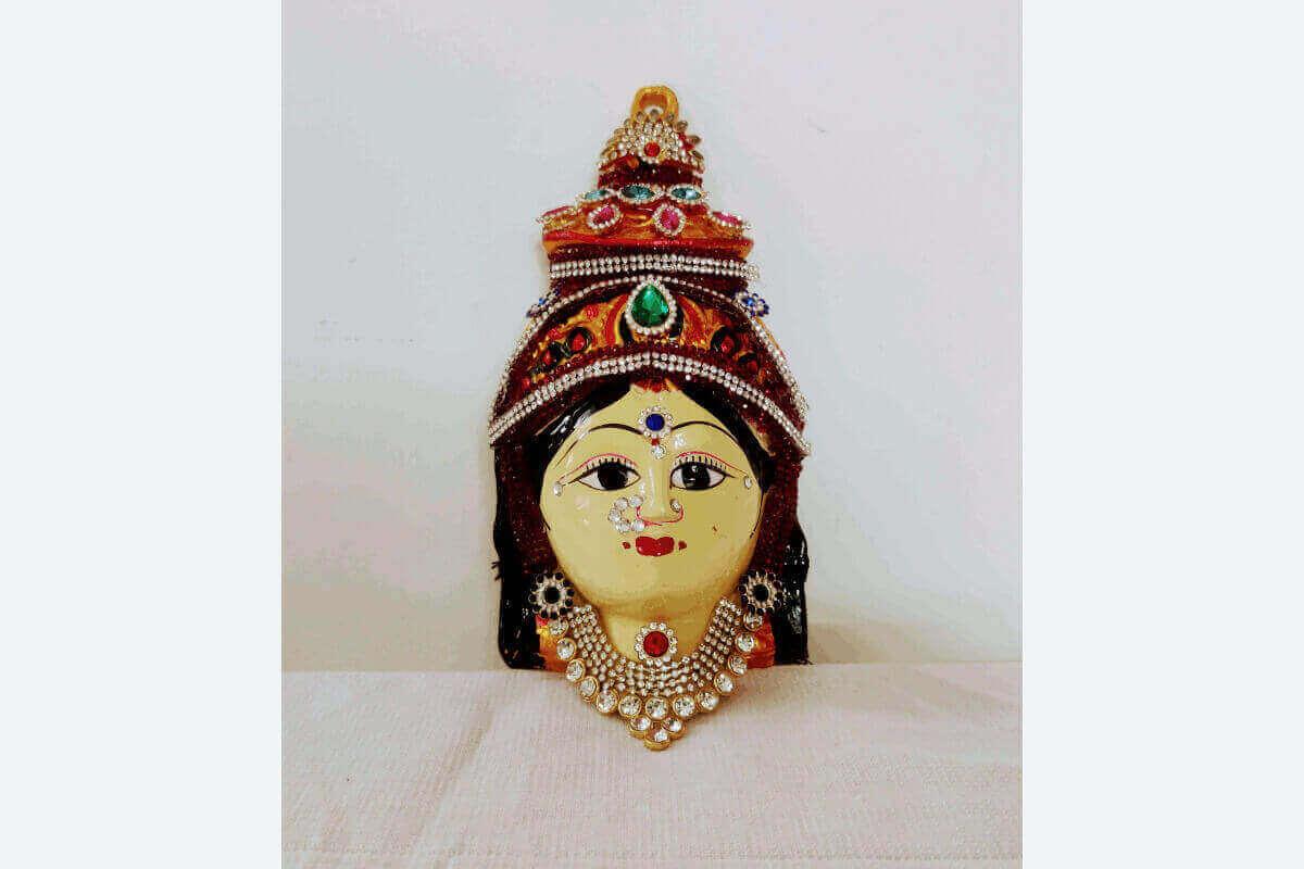 Rows of hand-painted skin-tone Ammavari faces in stock for bulk wholesale return gifts by Puja Celebrations