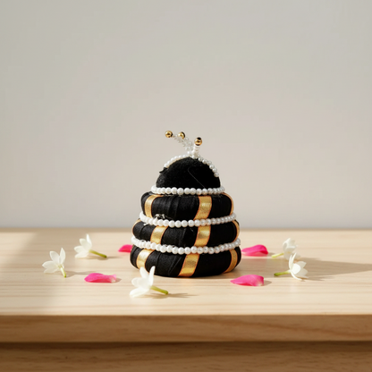 Decorative beehive sculpture with flowers on a wooden surface