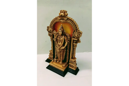 Small golden statue in a decorative stand on a white background