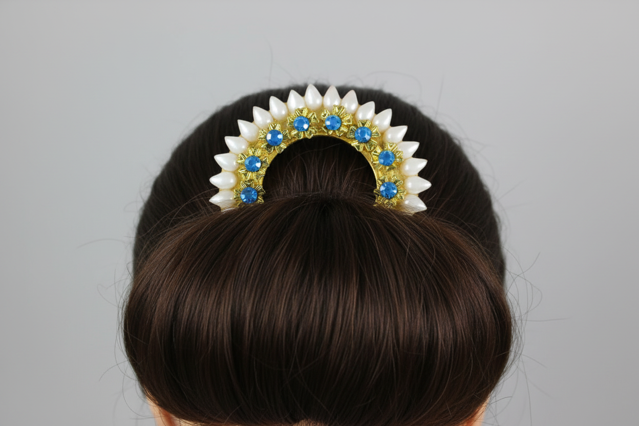 Hair bun with decorative hair accessory featuring blue stones on a gray background