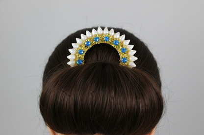 Hair bun with decorative hair accessory featuring blue stones on a gray background