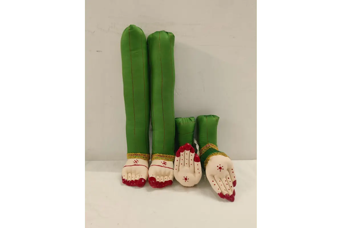 Green and white stuffed toys with red accents on a white background