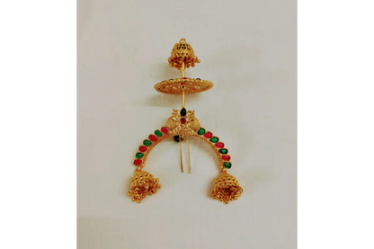 Gold earrings with green and red stones on a white background