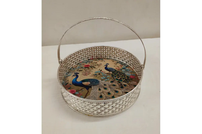 Decorative basket with peacock design on a white surface