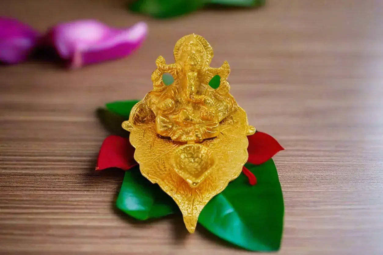 Detailed carving of Ganesha on white metal leaf