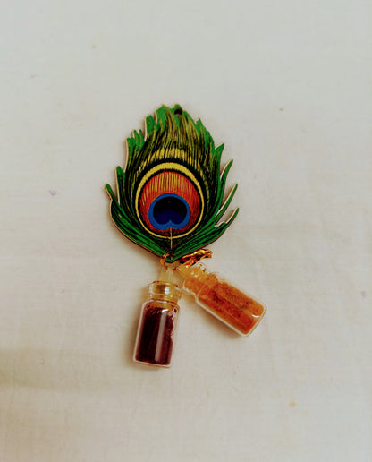 Pin with peacock feather and small bottles on a white background