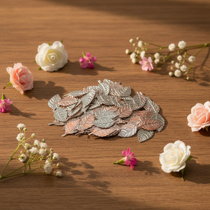 Decorative leaves on a wooden surface with small flowers around