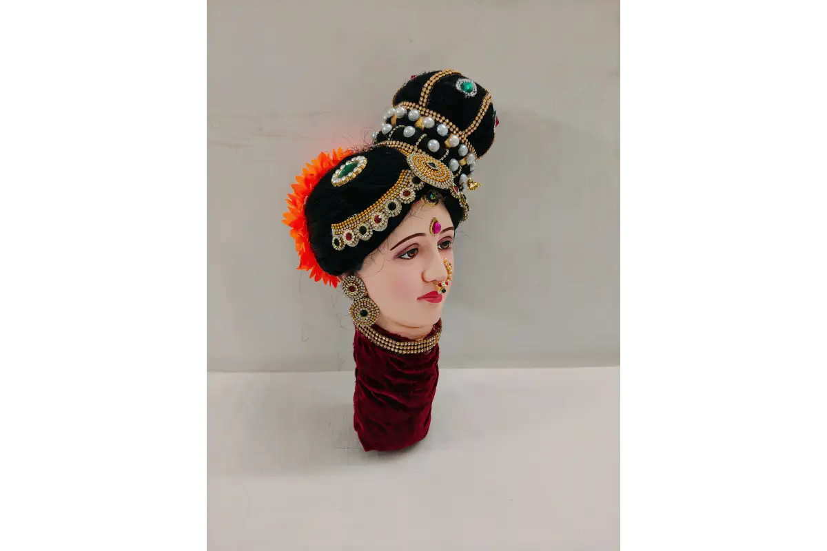 Traditional Indian headress with decorative elements on a neutral background