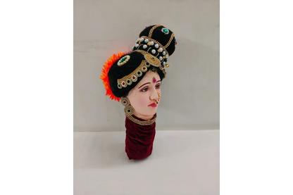 Traditional Indian headress with decorative elements on a neutral background