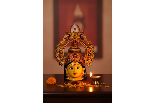 Traditional yellow metal Amman face with intricate peacock arch prabhavali for Varalakshmi Vratham kalash alankaram - PujaCelebrations