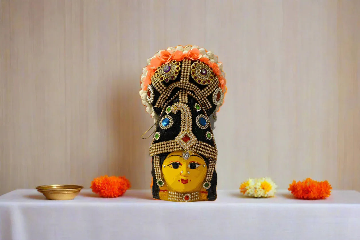andcrafted Varalakshmi Amman face with pre-decorated hair bun attached to a festive puja kalasham setup