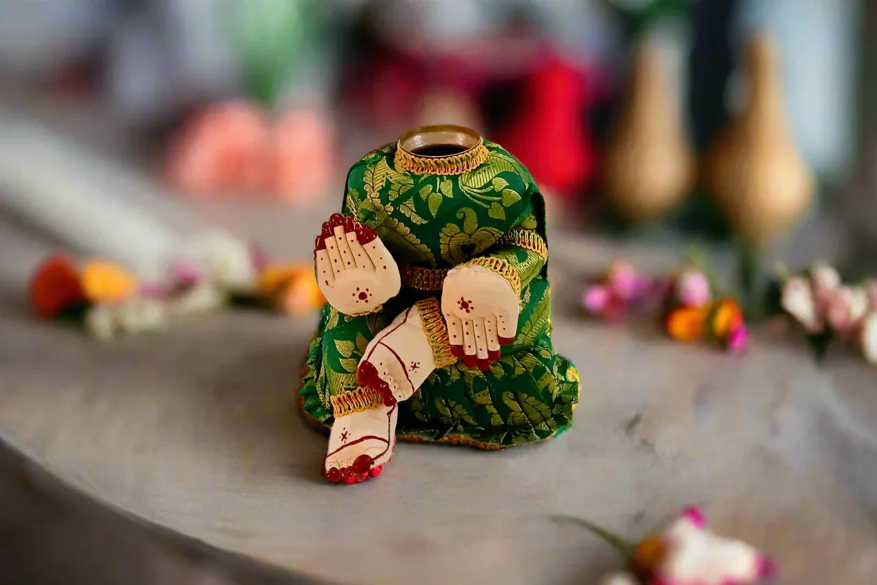 Goddess Amman festival doll draped in a silk saree utilizing a stable metal alankaram doll stand - Puja celebrations