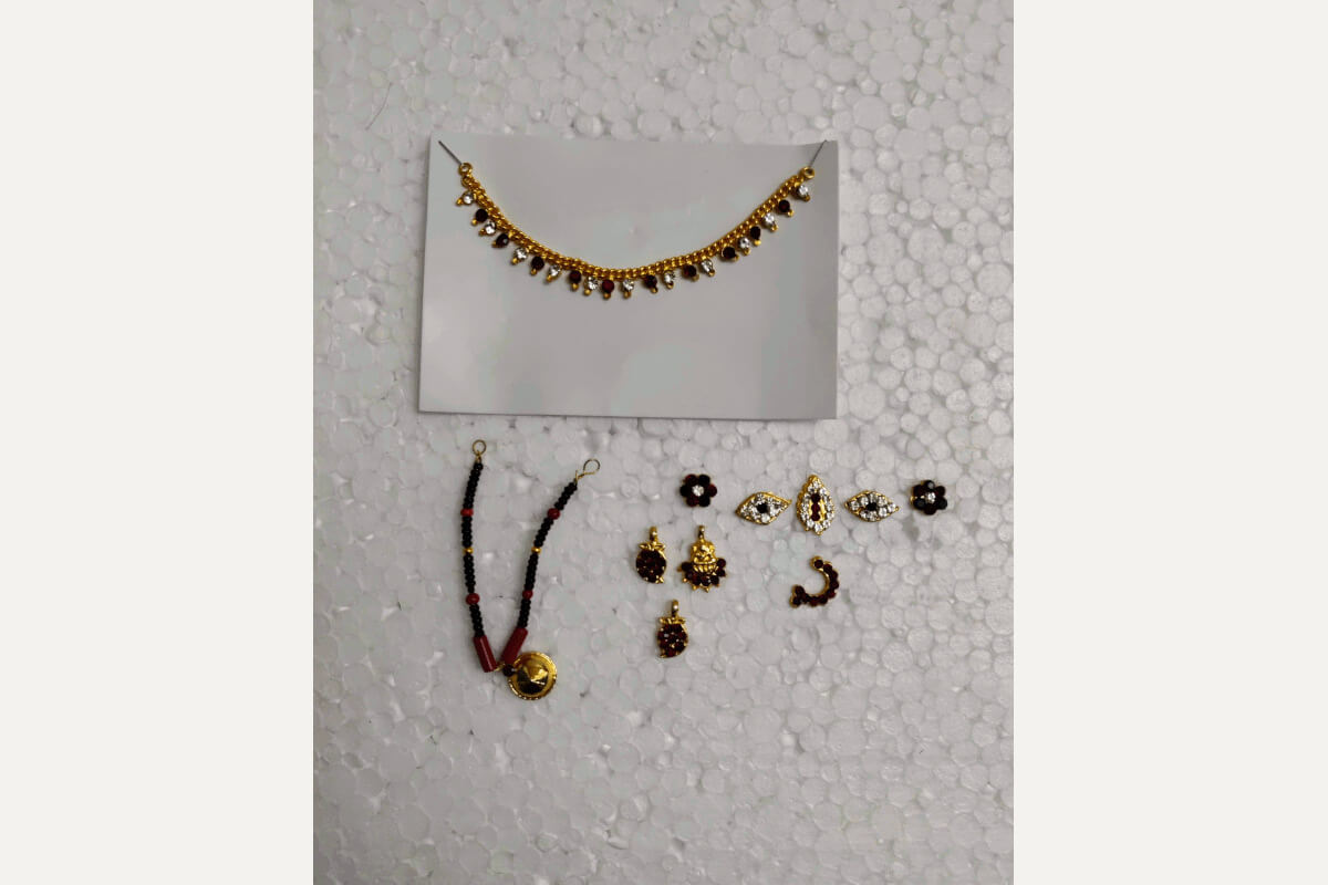 Close-up view of the intricate jewelry and traditional adornments included in the Goddess Devi pooja decoration set - Puja Celebrations