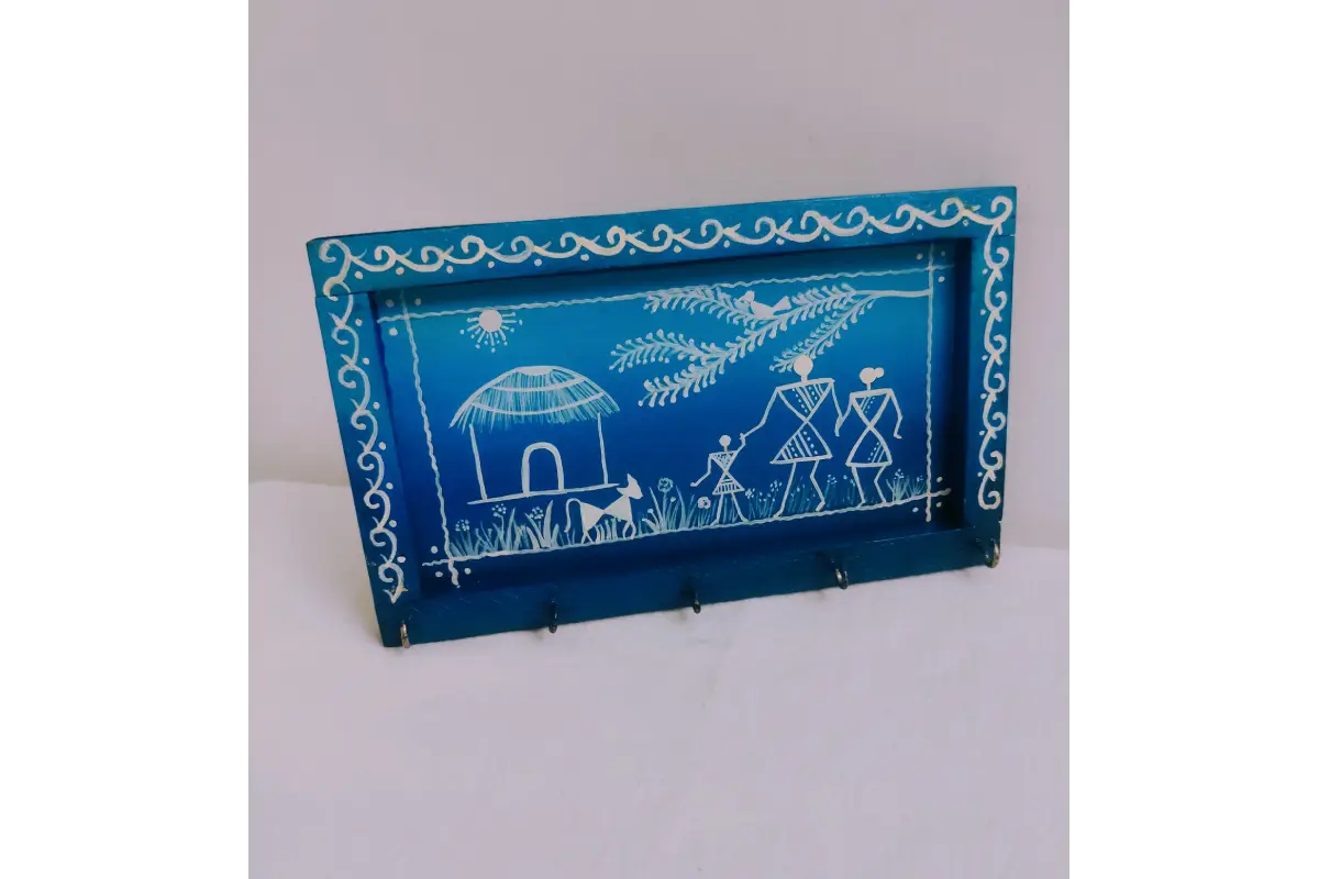 Wooden Warli tribal painting keyholder mounted on entryway wall organizing keys