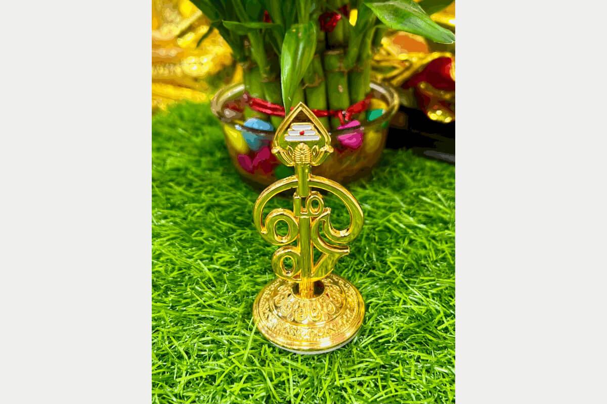 Polished gold finish Tamil Om Vel stand used as a divine accessory for daily rituals