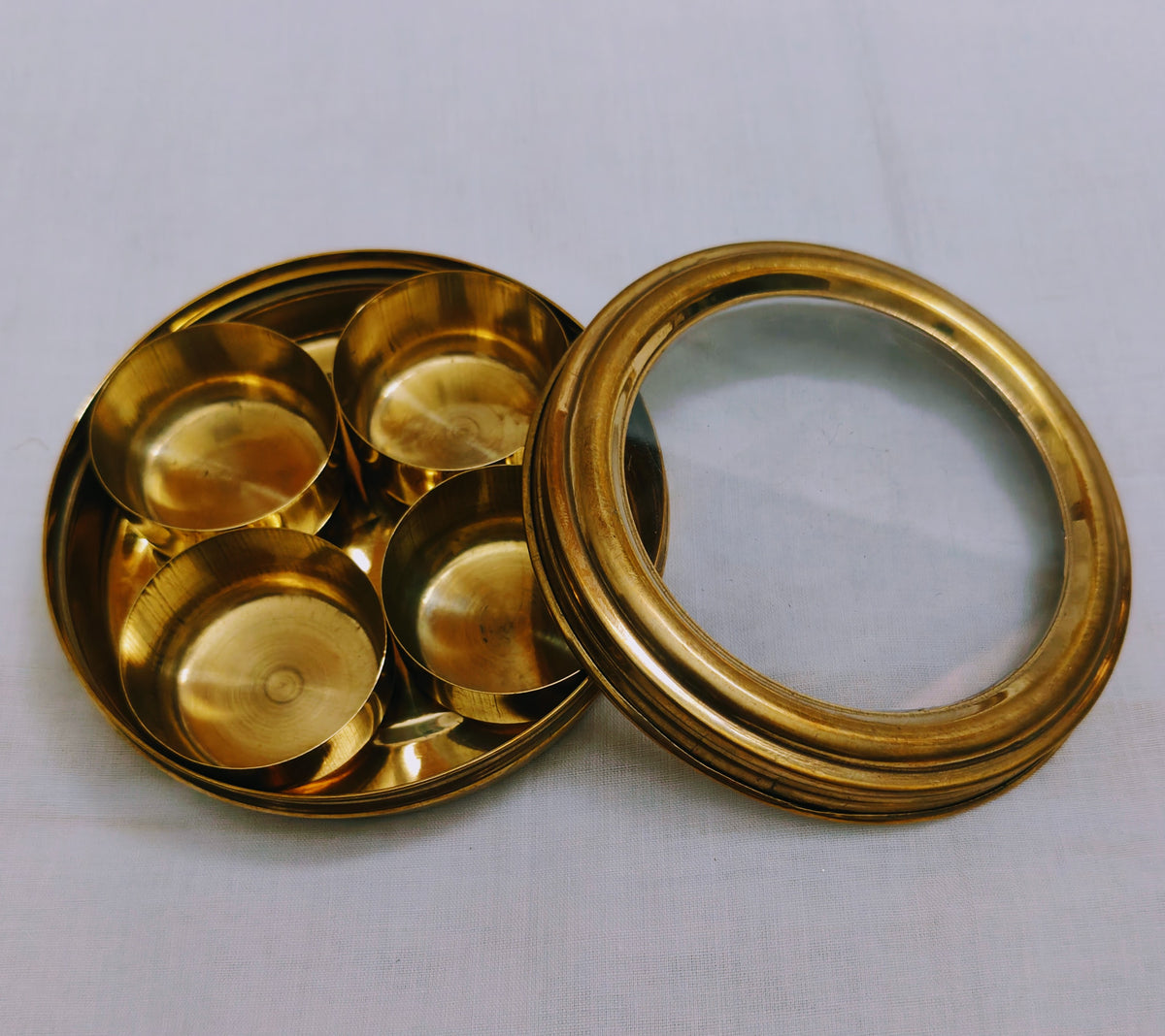 Close-up view of polished lid edge and heavy brass craftsmanship on Anjarai Petti