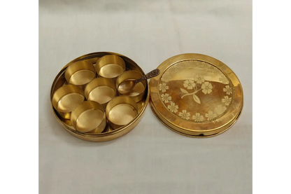Interior view of 7 cup brass spice dabba showing removable compartments for kitchen storage