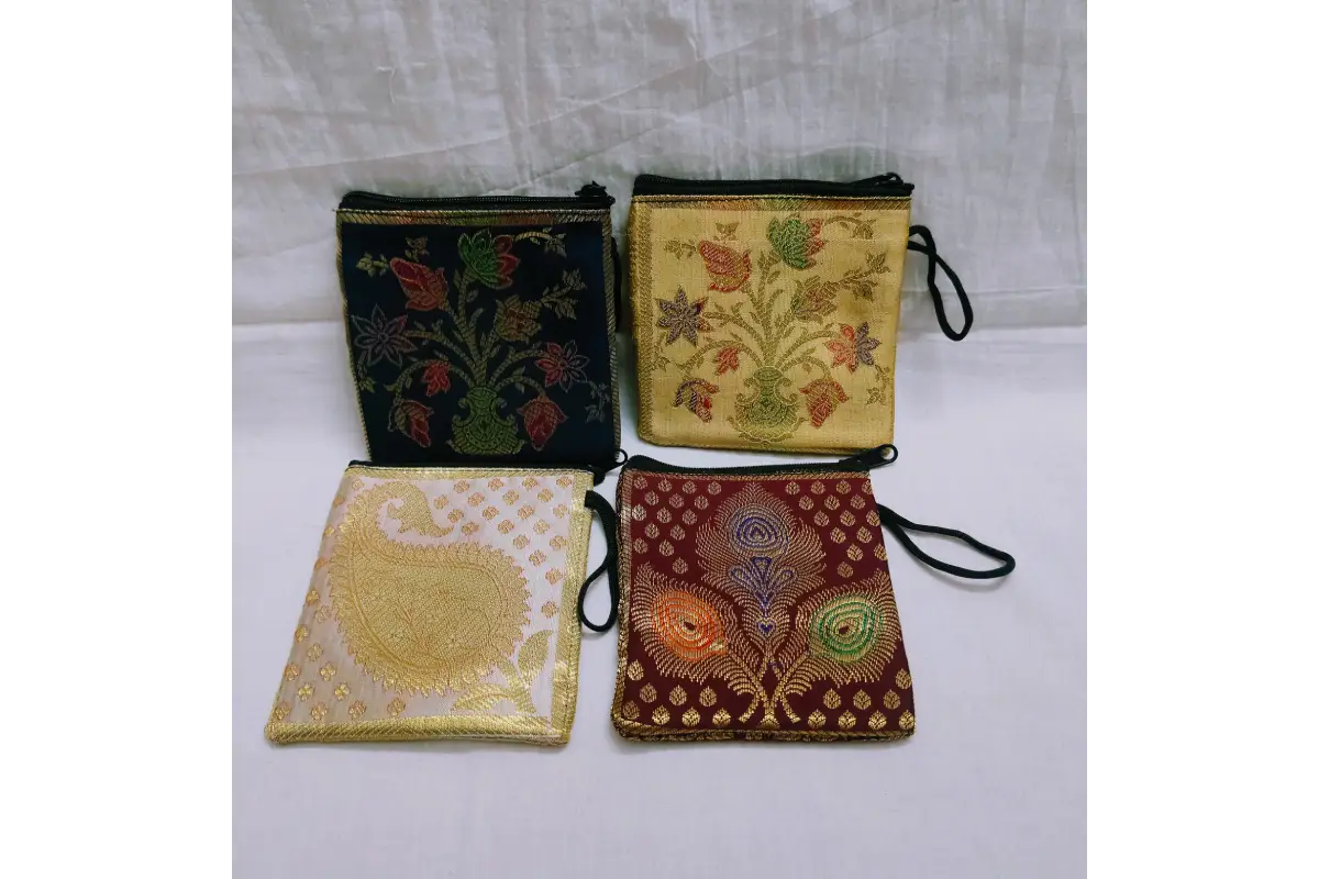 Close-up shot of rich golden zari embroidery on traditional silk brocade mini purse