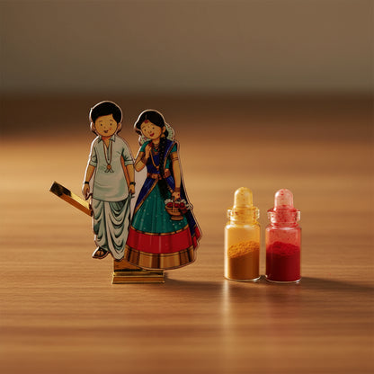 Two figurines of a man and woman with a small bottle containing red liquid on a white background