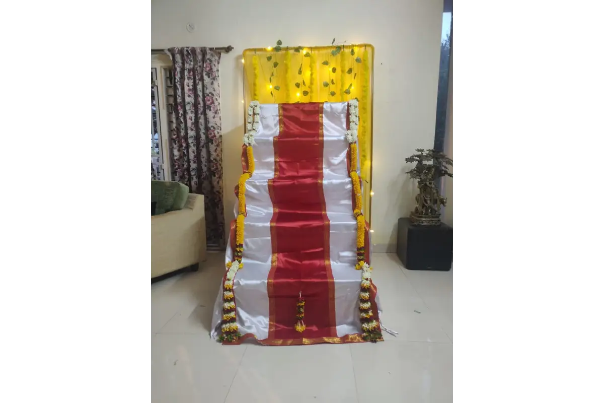 Close-up view of heavy gold zari border and premium satin fabric on tailored Golu stand cover