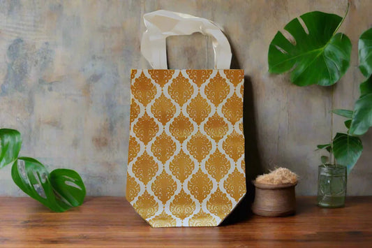 Close up of a glossy sheet paper gift bag with a sturdy rope handle used for thamboolam