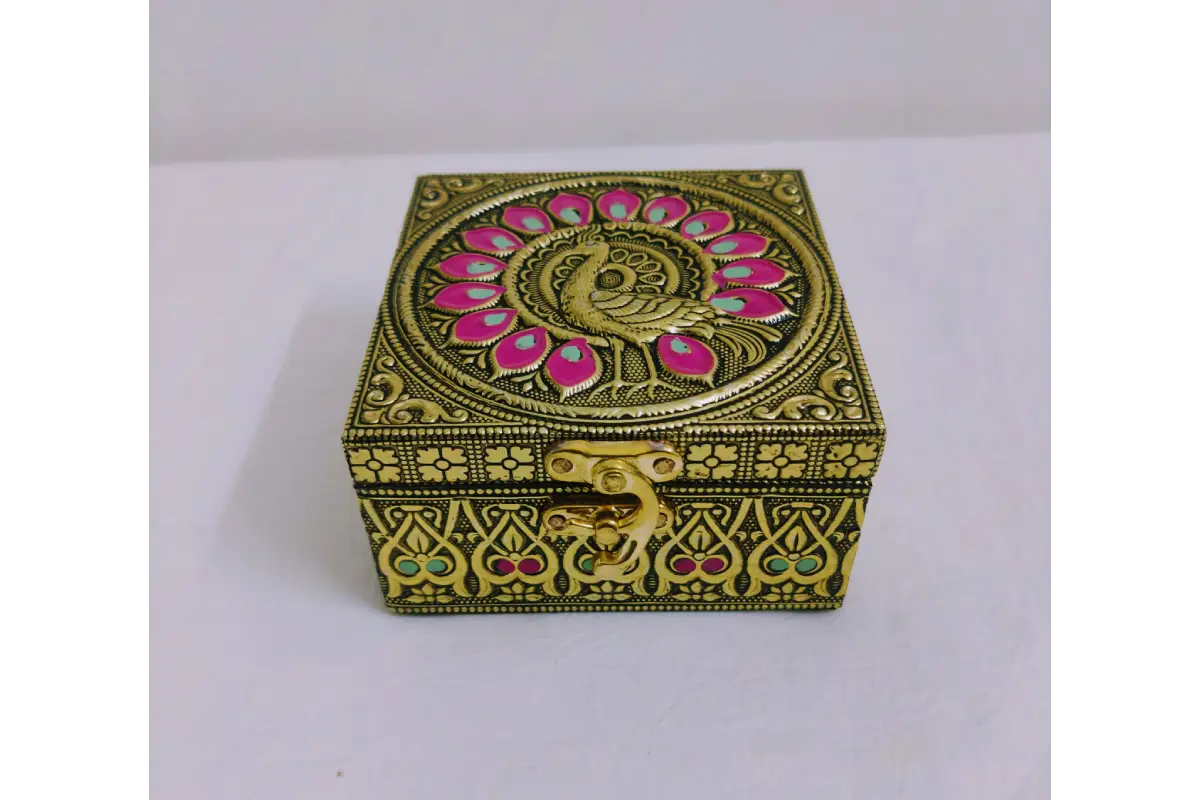 Open embossed jewel box filled with gold jewelry and dry fruits showing storage capacity