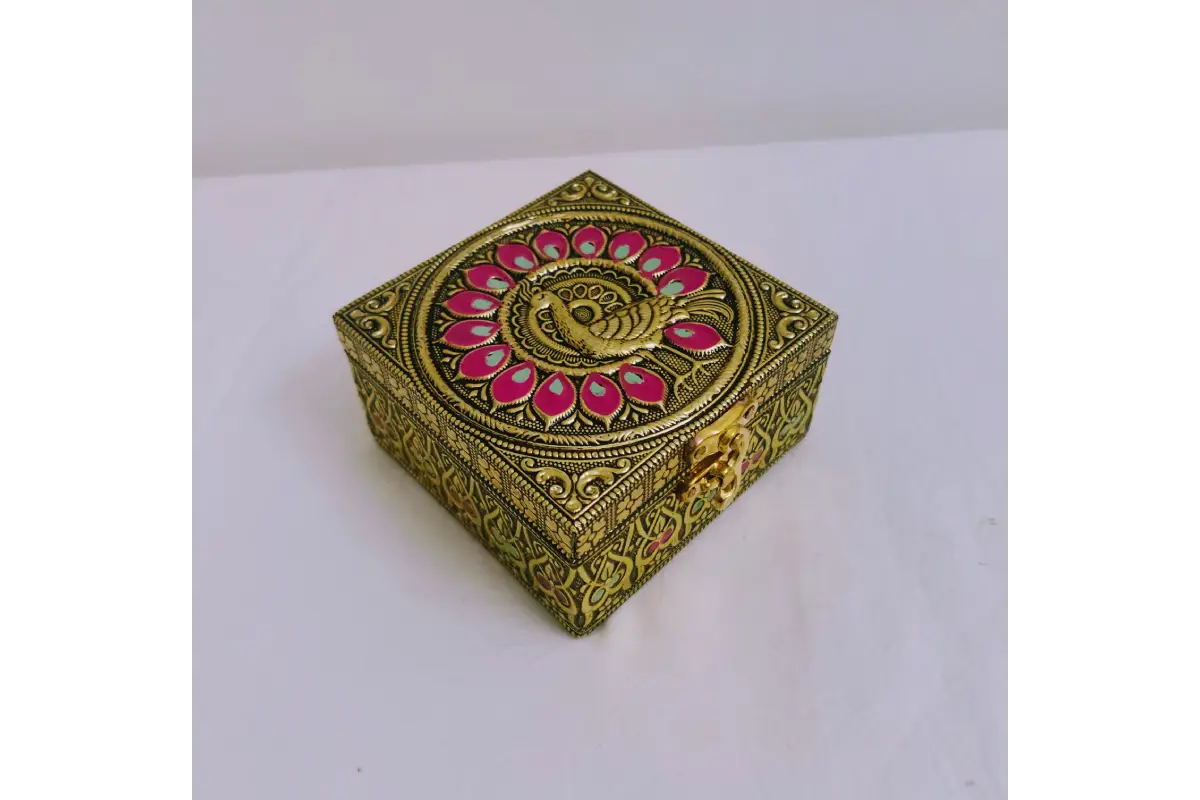 Embossed jewel box arranged in housewarming thamboolam setup with coconut and flowers