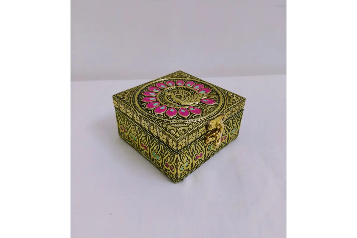 Traditional embossed jewel box held in palm showing compact size for return gifting