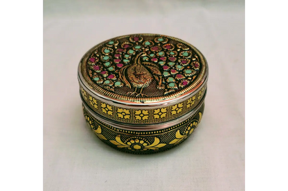 Embossed steel box filled with dry fruits arranged for housewarming and wedding guests