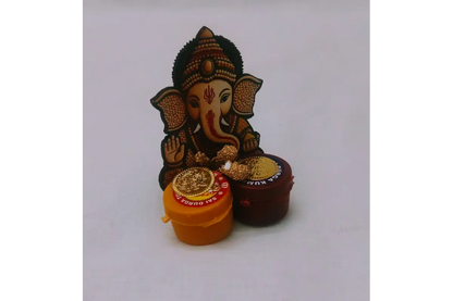 Ganesha Haldi Kumkum magnet attached to a refrigerator door as decorative accent