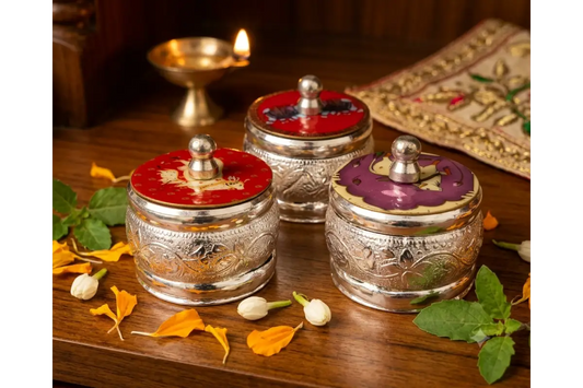 Classic dome-shaped German Silver sindoor box with intricate floral relief carvings on a plain white background