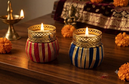 Close-up view of vibrant handpainted traditional patterns and gold accents on clay matka candle