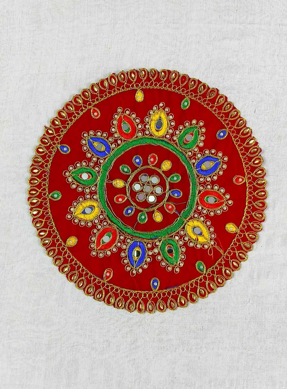 Top view of traditional wooden Rangoli Puja Chowki Asan with colorful painted Kolam designs - Puja Celebrations