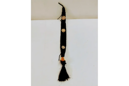 Black belt with gold floral patterns on a white background