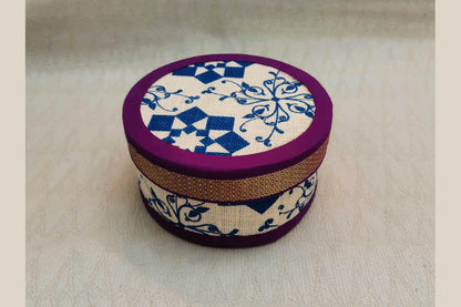 Sustainable jute storage box with a vibrant orange zari-style trim.