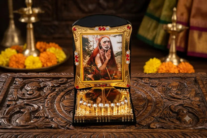 Close-up view of holy feet Charan Paduka and Sri Kanchi Maha Periyava portrait