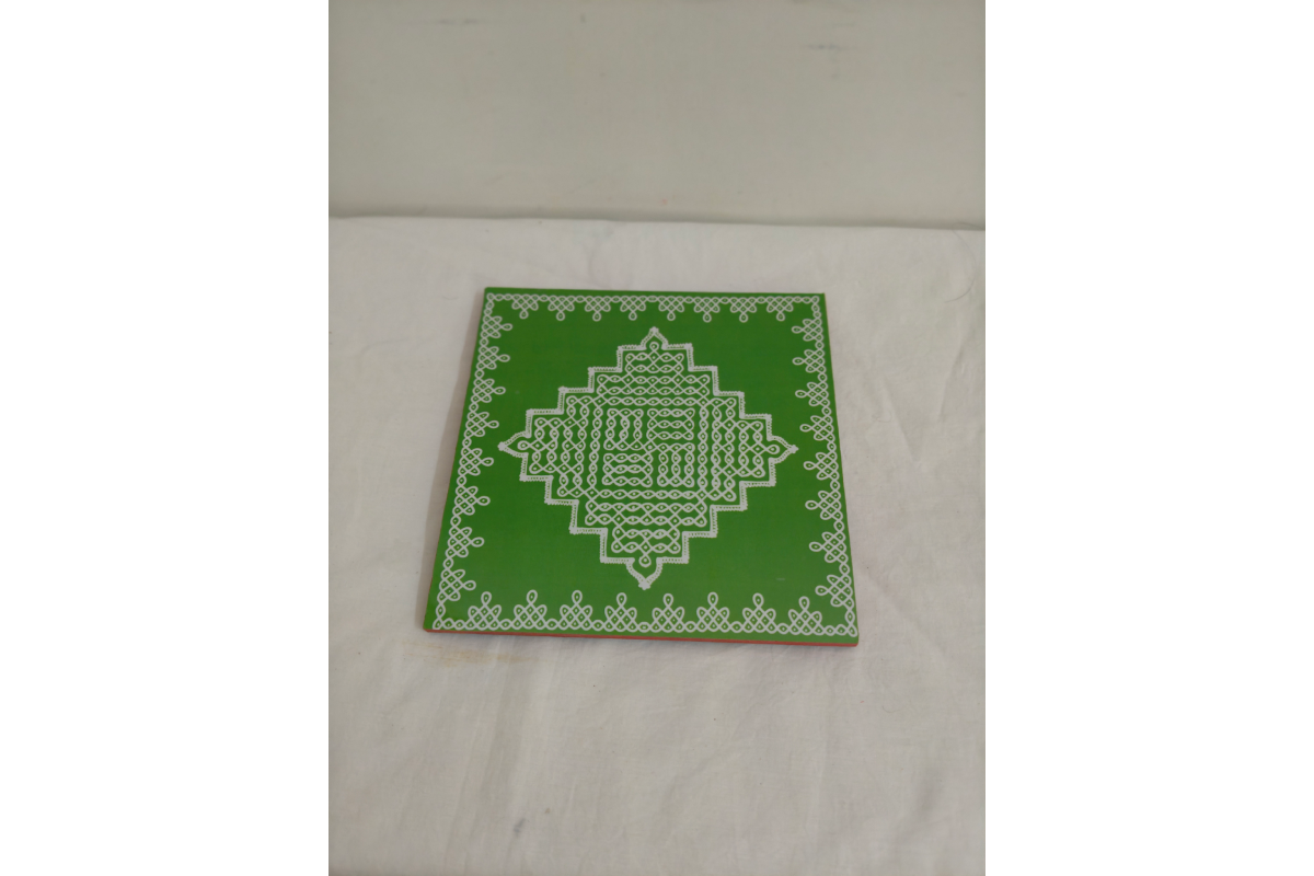Kolam Rangoli wooden manai patla held in hands showing compact size for return gifting