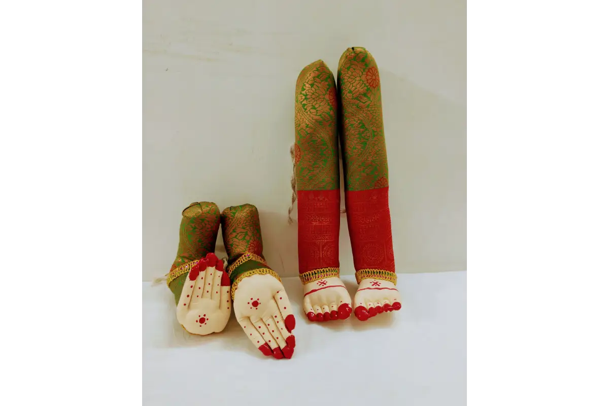 Set of four small figurines with green, red, and beige patterns on a white background