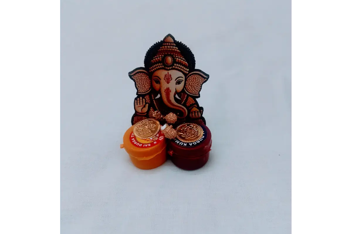 Close-up view of vibrant Lord Ganesha motif and dual Haldi Kumkum boxes - Puja Celebrations