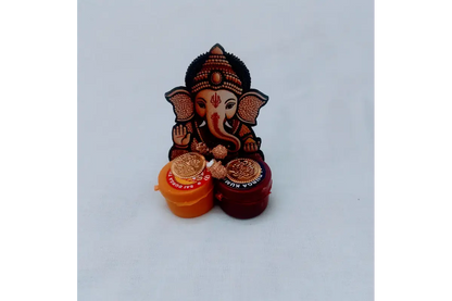 Close-up view of vibrant Lord Ganesha motif and dual Haldi Kumkum boxes - Puja Celebrations