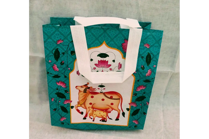 Close-up view of intricate Pichwai lotus flower and divine cow print on fabric gift bag