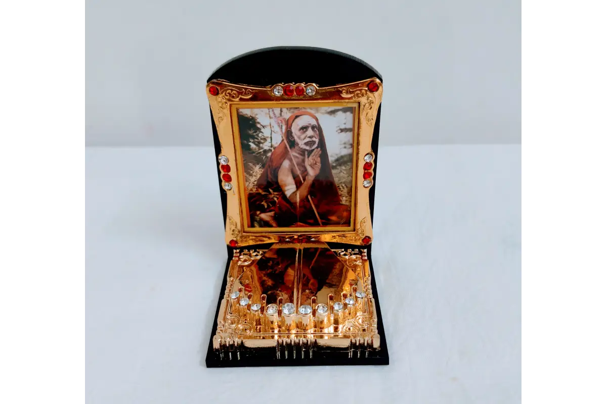 Maha Periyava Charan Paduka frame mounted on a car dashboard for divine travel safety
