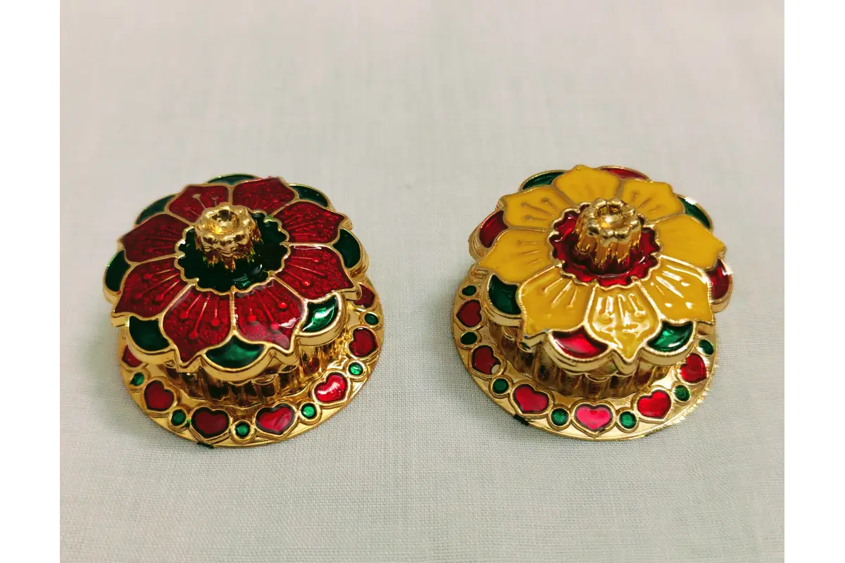 Close-up view of vibrant hand painted Meenakari enamel artwork on Kumkum box lid