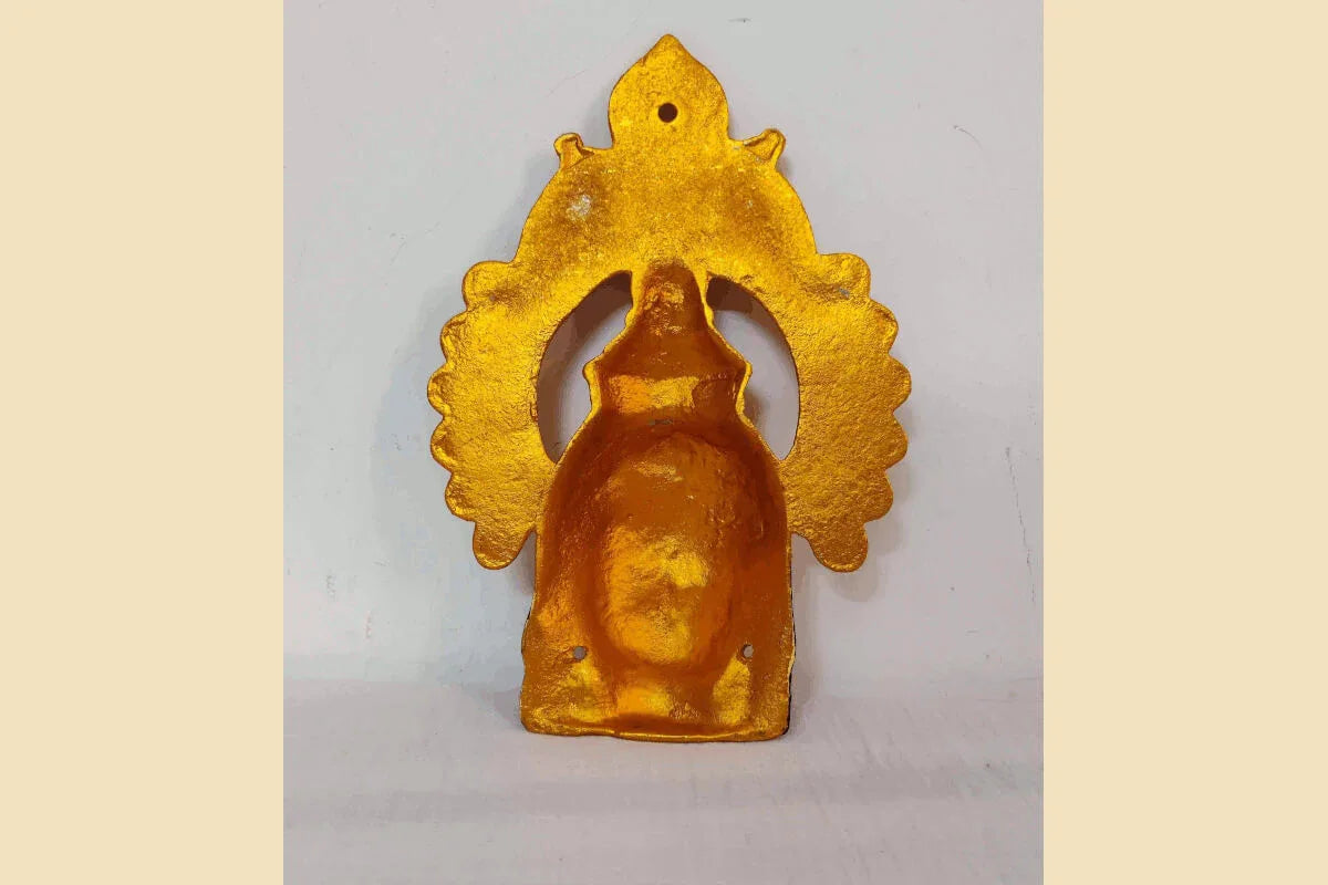 Decorated metal Amman face with an ornate peacock arch - Puja Celebrations