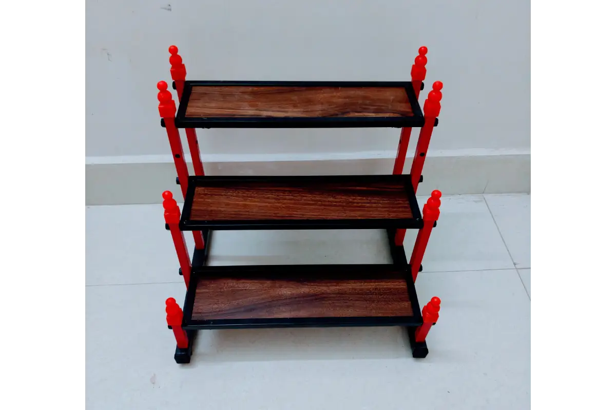 Mini Golu padi placed on a wooden mandir shelf decorated for Navaratri Golu
