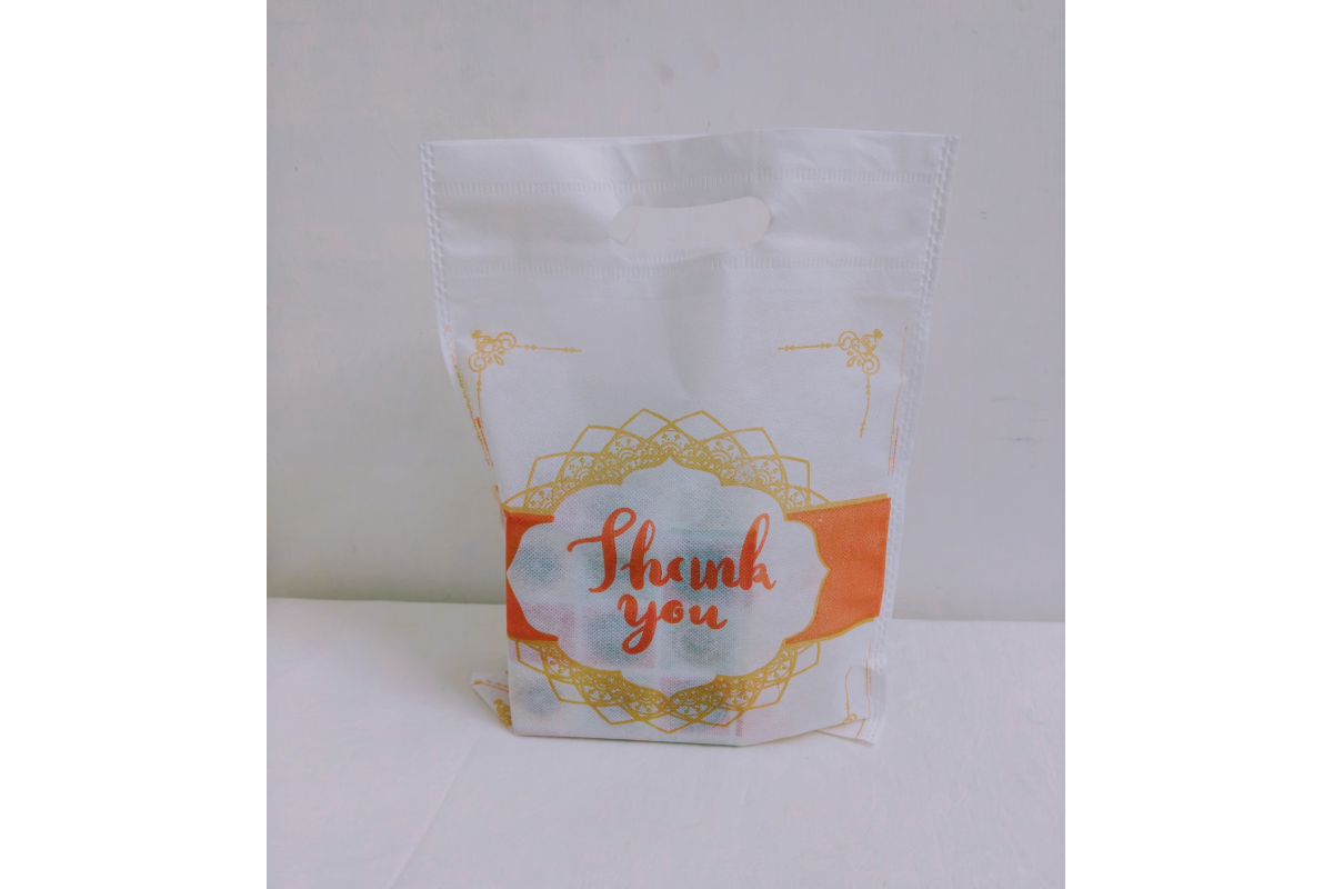 Close-up view of non-woven fabric texture and clear Thank You print bag
