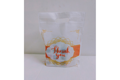 Close-up view of non-woven fabric texture and clear Thank You print bag
