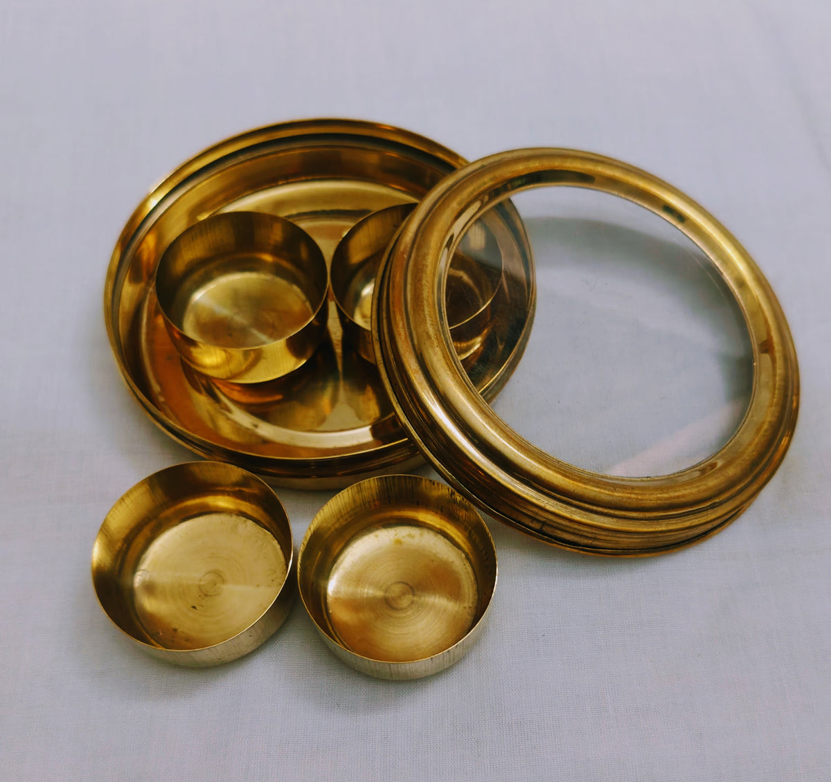 Open brass masala box showing 4 removable inner katori spice bowls