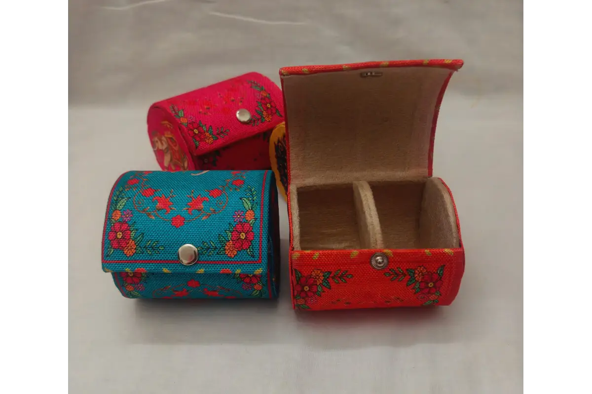 Open printed bangle organizer showing inner velvet lining and central holding rod